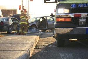 emergency responder helps injured car accident victim