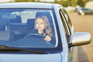 young teenage woman driving a car