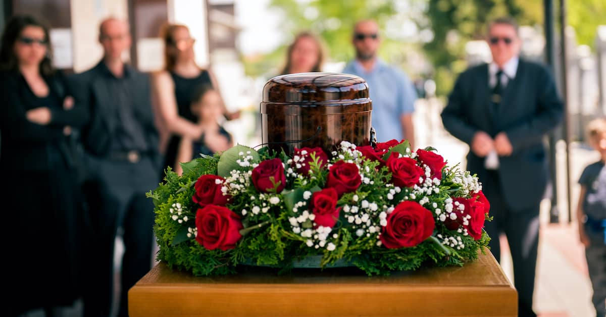 mourning family gathered around the urn of a deceased loved one