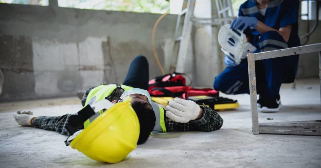 paramedic preparing neck brace for construction worker lying injured on a building site