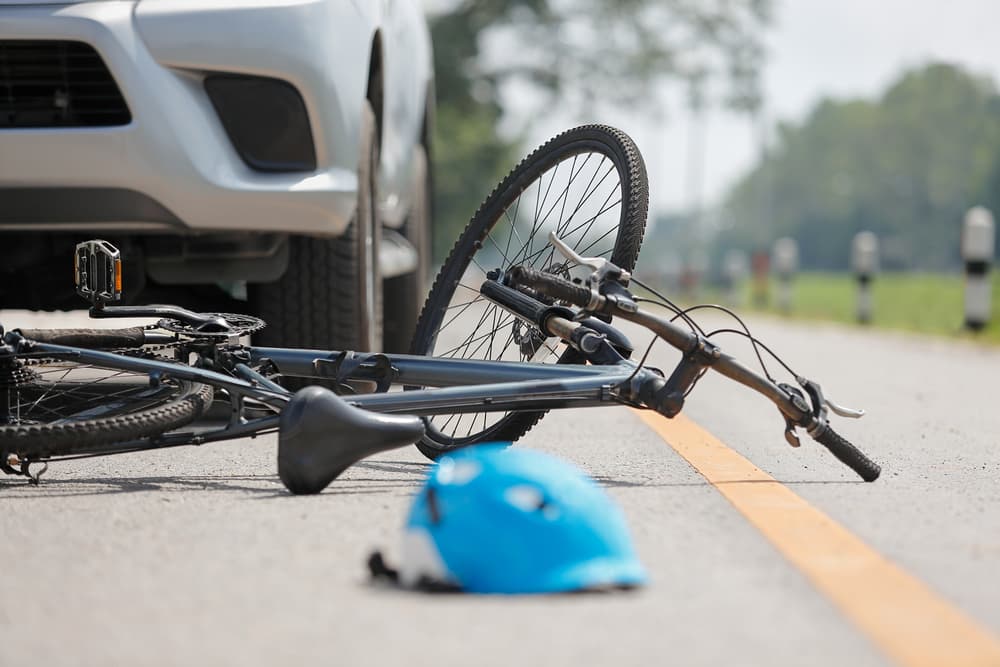 Car collides with bicycle on the road in an accident.






