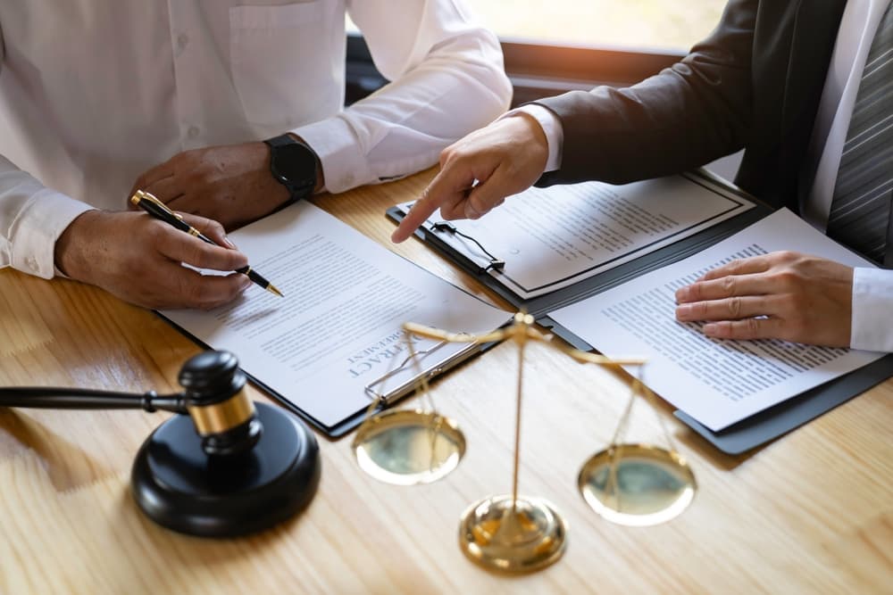 Attorneys or lawyers reviewing the statute of limitations: Discussion between male lawyers and business clients, involving tax and legal services firms.






