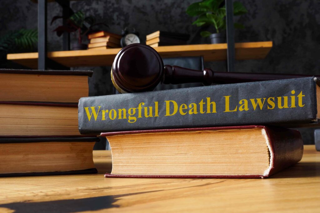 Wrongful death lawsuit book with judge’s gavel on desk in law office.