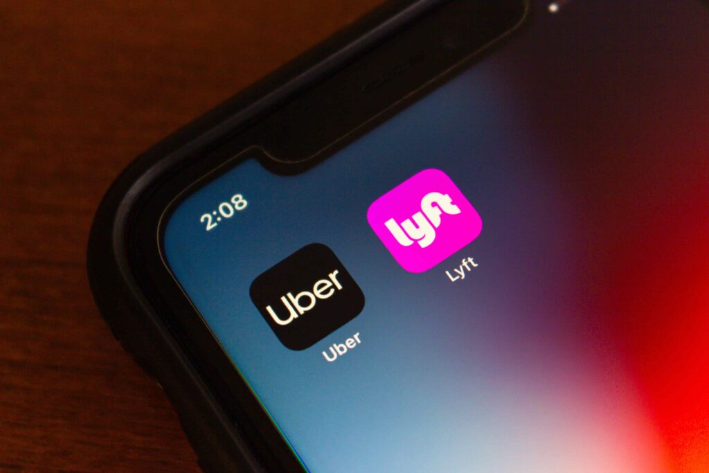 Uber and Lyft rideshare apps on phone screen, representing rideshare accident claims. Uber and Lyft rideshare apps on phone screen, representing rideshare accident claims.