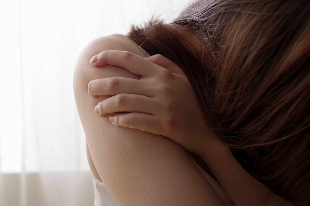 Bridgeport Sexual Assault Lawyer supporting a survivor shown holding their shoulder in distress.