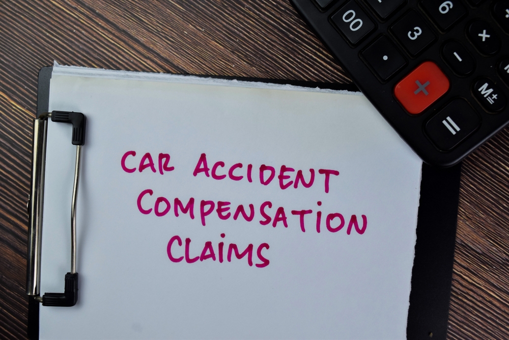 Connecticut car accident lawyer reviewing settlement paperwork and cash payment after a vehicle collision.