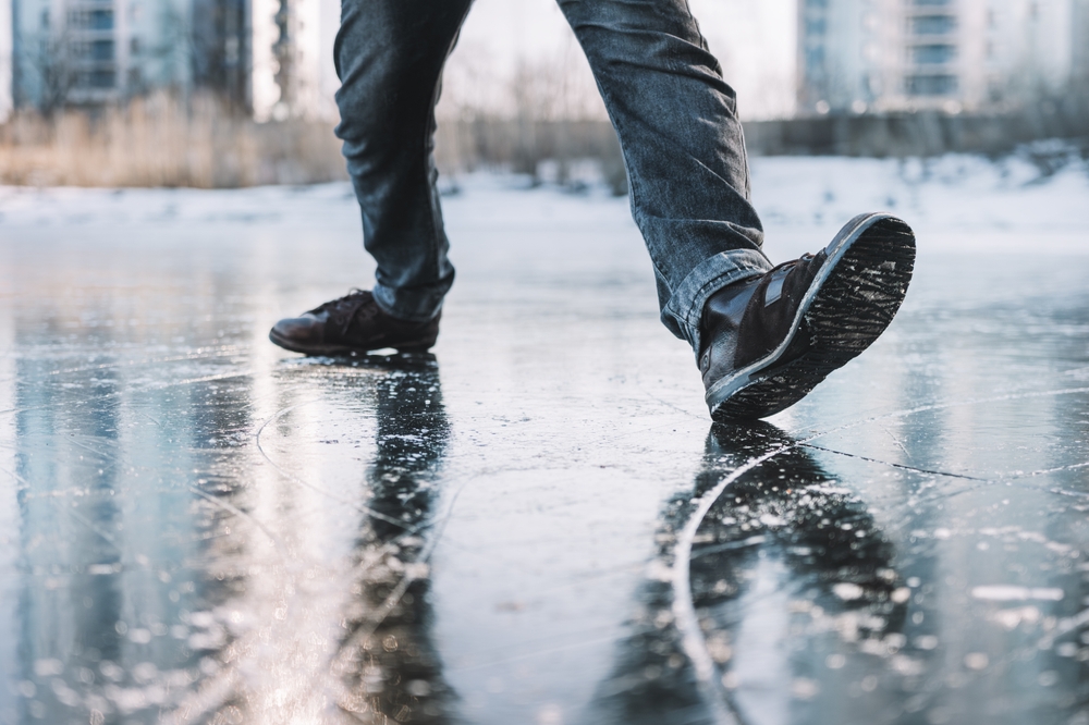 Connecticut slip and fall accident lawyer example of person slipping on icy pavement outdoors.