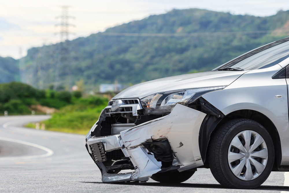Damaged vehicle on a Connecticut roadway after a crash, representing cases handled by a Connecticut car accident lawyer.