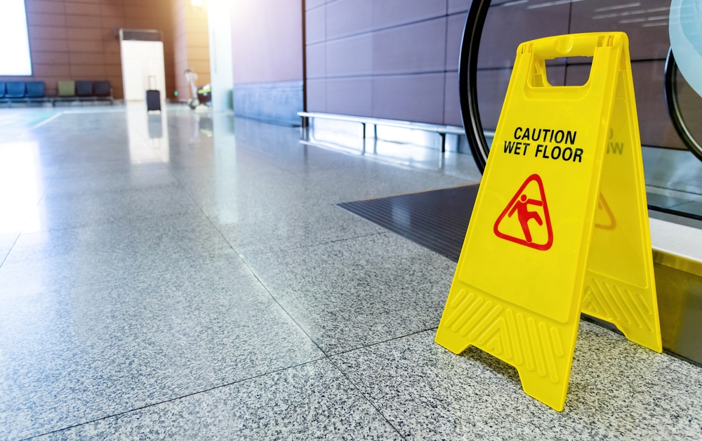 Wet floor caution sign in public space showing hazard relevant to Danbury slip and fall lawyers