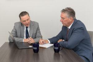 Brian and Christopher Flood reviewing case documentation