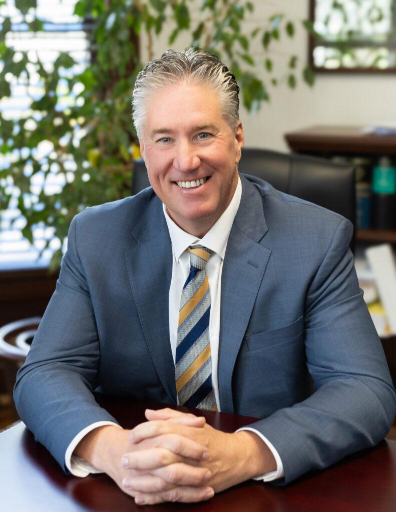 Attorney Brian Flood headshot in office