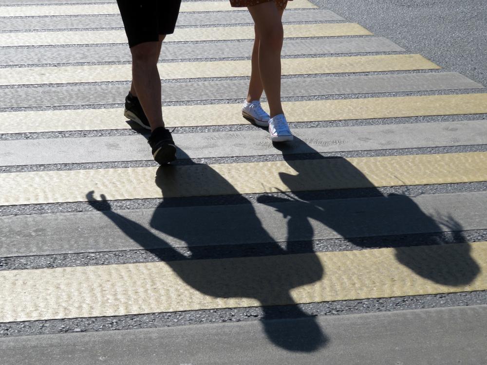 Pedestrians using crosswalk to cross a street